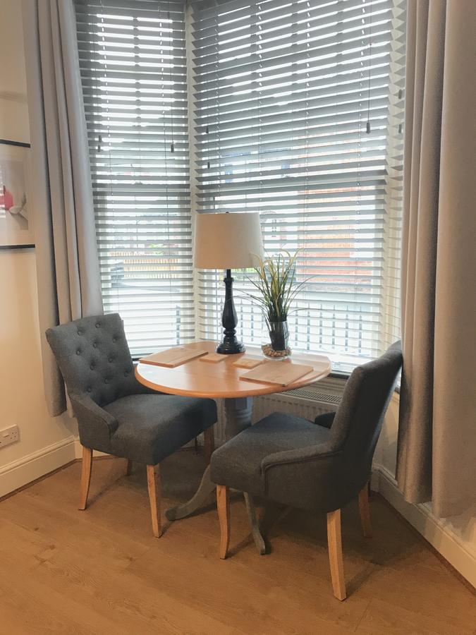 The Larches Hotel Wolverhampton Exterior photo A table and chairs in a window seat